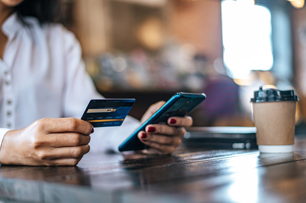woman using credit card to pay for legacy management software online